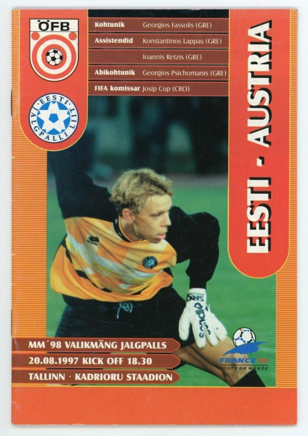 Soccer card from the 1998 FIFA World Cup featuring a player in a jersey with a determined expression against a bright blue sky with white clouds.