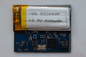 Nahaufnahme einer Smartphone-Batterie mit aufgedrucktem Text auf einer weißen Oberfläche über einer Leiterplatte.