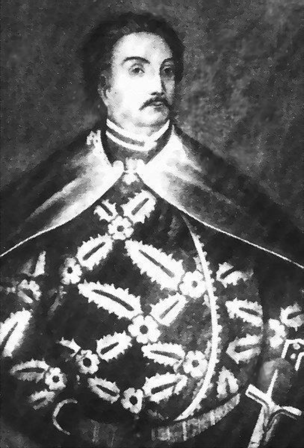 Schwarzes und weißes Foto von Papst Johannes Paul II. in Priesterrobe, der eine schwarze Robe mit weißem Kragen und Manschetten trägt, die Hände gefaltet, strenger Gesichtsausdruck, direkt in die Kamera schaut.